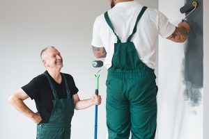 Professional renovation crew painting walls of new build apartment
